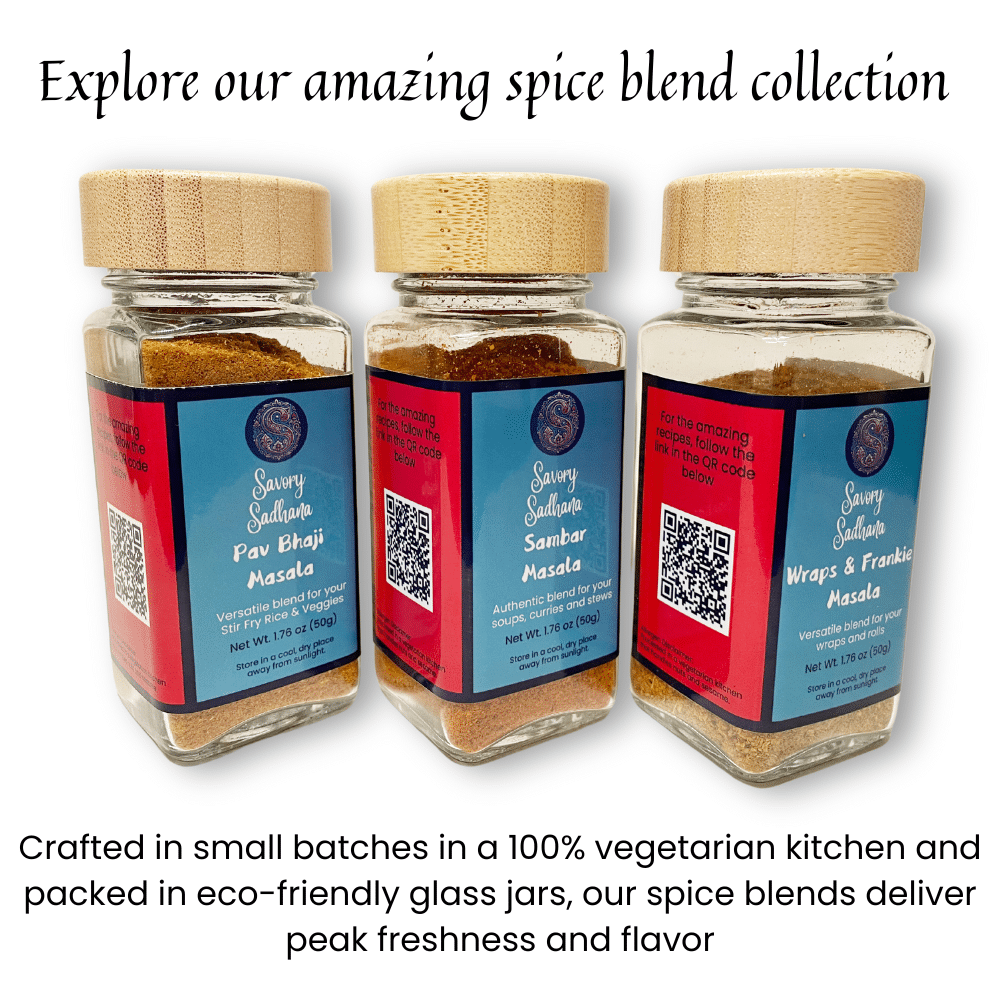 Three spice jars labeled Pav Bhaji Masala, Sambar Masala, and Wraps & Frankie Masala from Savory Sadhana, each in eco-friendly glass jars with bamboo lids and QR codes on the labels. Caption above reads ‘Explore our amazing spice blend collection.’ Below the jars, text reads ‘Crafted in small batches in a 100% vegetarian kitchen and packed in eco-friendly glass jars, our spice blends deliver peak freshness and flavor.